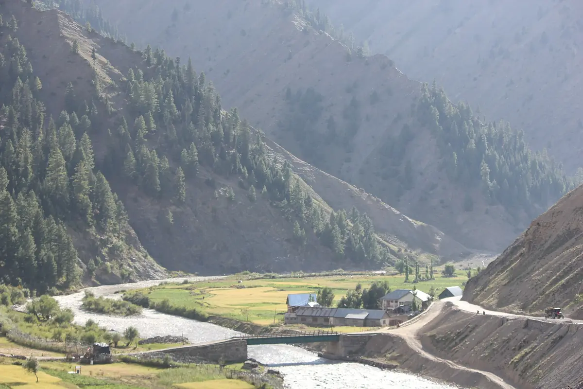 The road and river through the Gurez valley between steep slopes