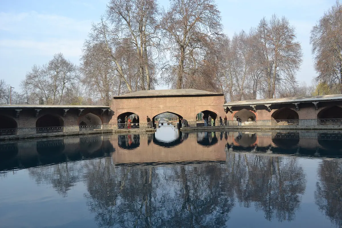 Verinag's arcade and spring pool under bare chinar trees